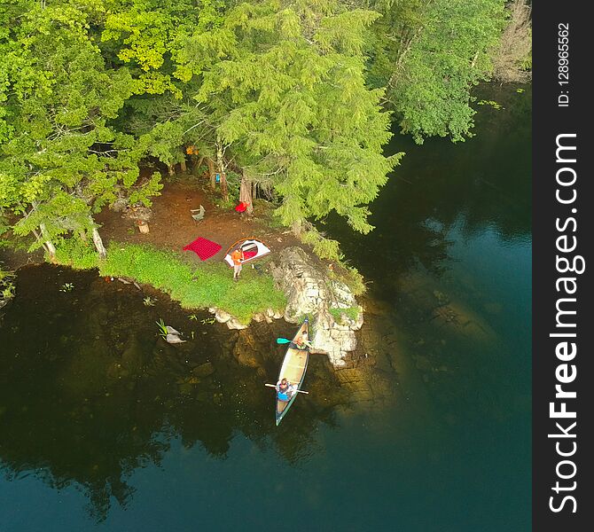 Aerial drone shot of tent Campsite and canoe in the Adirondack Mountains. Summer camping near lake in the wilderness. Aerial drone shot of tent Campsite and canoe in the Adirondack Mountains. Summer camping near lake in the wilderness