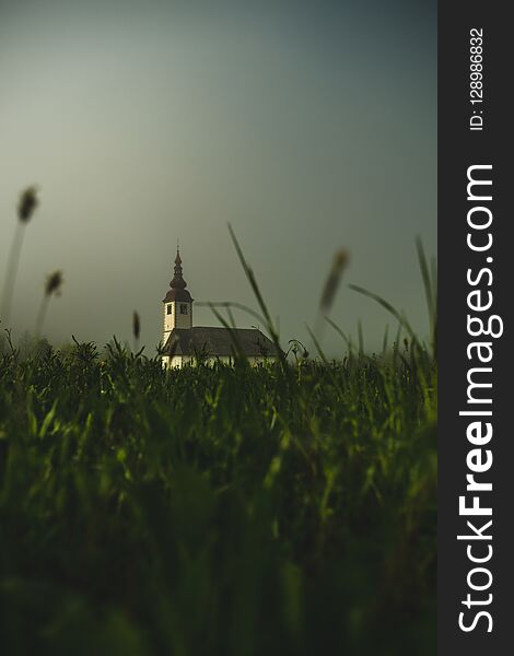 Picture of a church emerging from a morning fog in Slovenia, Bohinjska Bistrica. Picture of a church emerging from a morning fog in Slovenia, Bohinjska Bistrica.