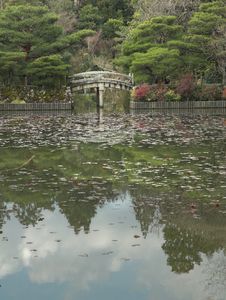 Reflections Of A Japanese Garden And A Stone Bridge Royalty Free Stock Images
