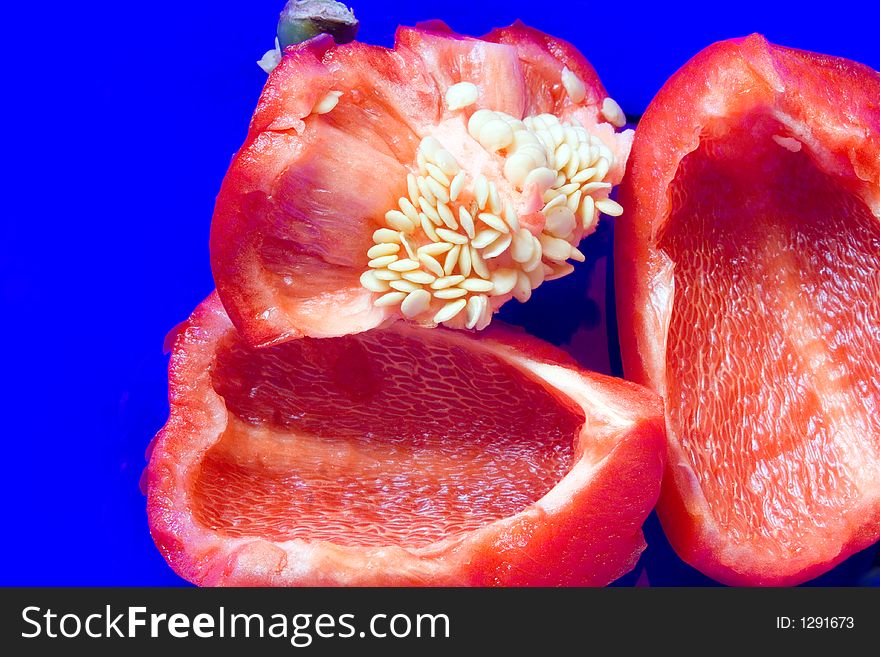 Wet red bell peppers in a cobalt blue bowl