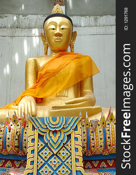 Big buddha statue among some ancient ruins. Thailand Buddhist art.