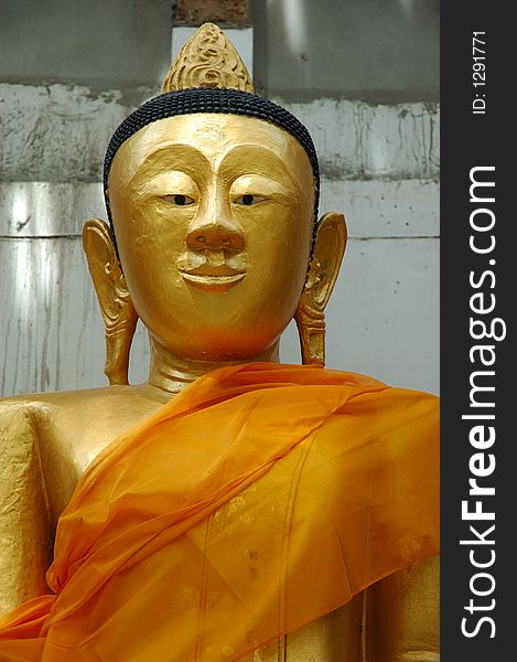 Gold Buddha statue with big ears