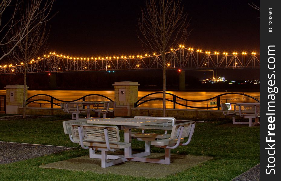 Picnic table by the bridge at night. Picnic table by the bridge at night.