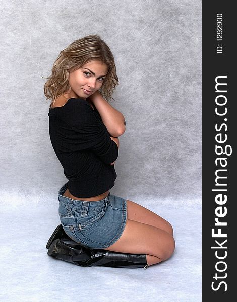 Pretty girl wears jeans skirt and black boot
