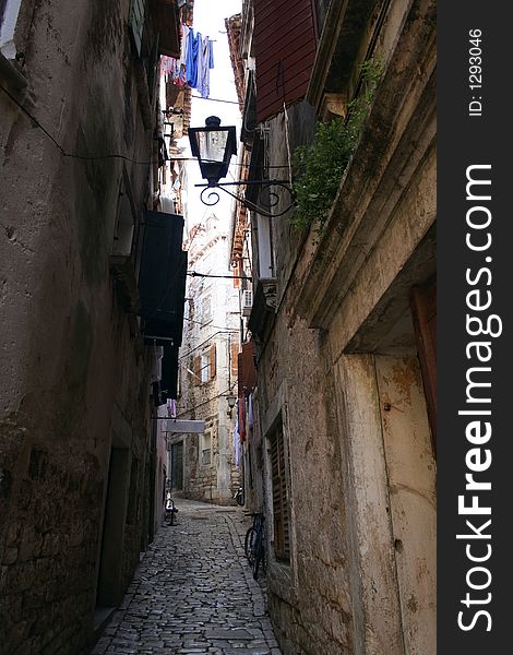 An alley in Novigrad, Croatia. An alley in Novigrad, Croatia