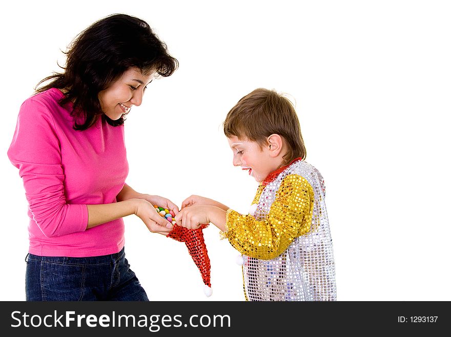 Woman giving sweets to a boy-clown on halloween. Woman giving sweets to a boy-clown on halloween
