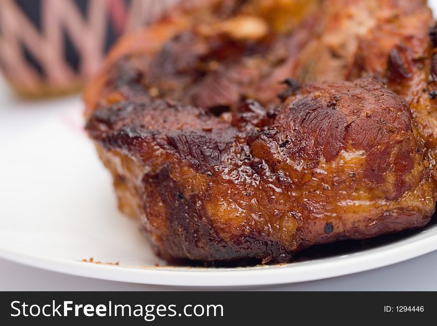 Baked in foil with honey pork meat and a bottle of wine, close-up. Baked in foil with honey pork meat and a bottle of wine, close-up.