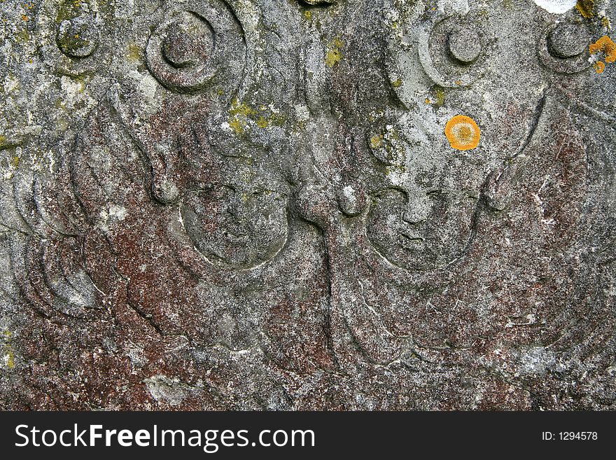 Angel faces on an old gravestone. Angel faces on an old gravestone