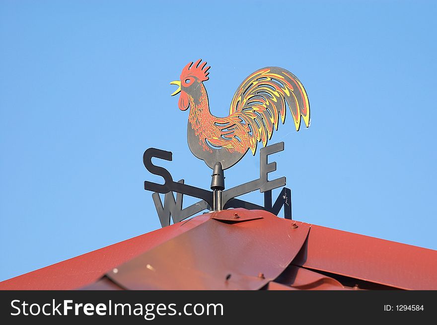 Weathercock on the red roof