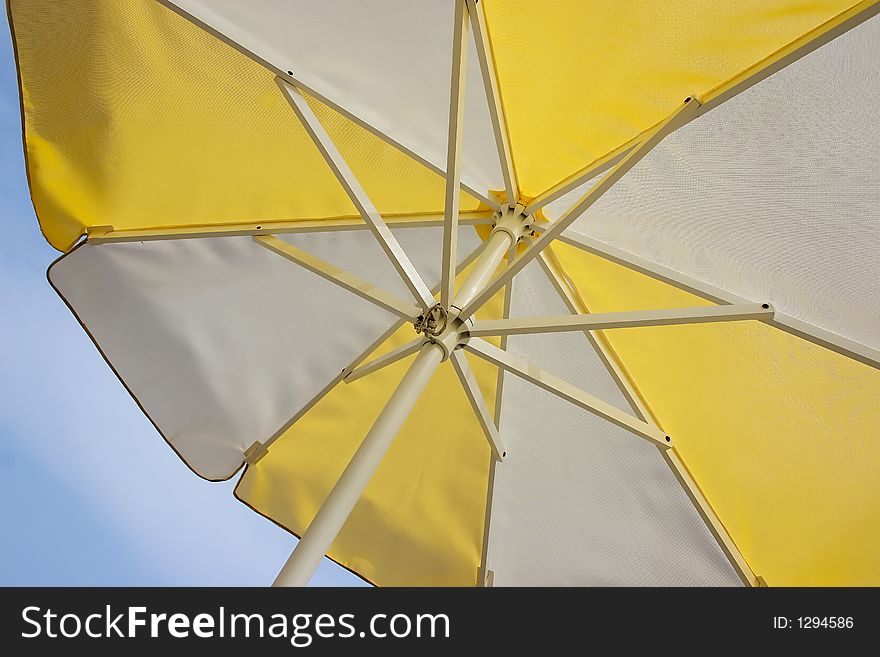 Sunshade in white and yellow against the sky