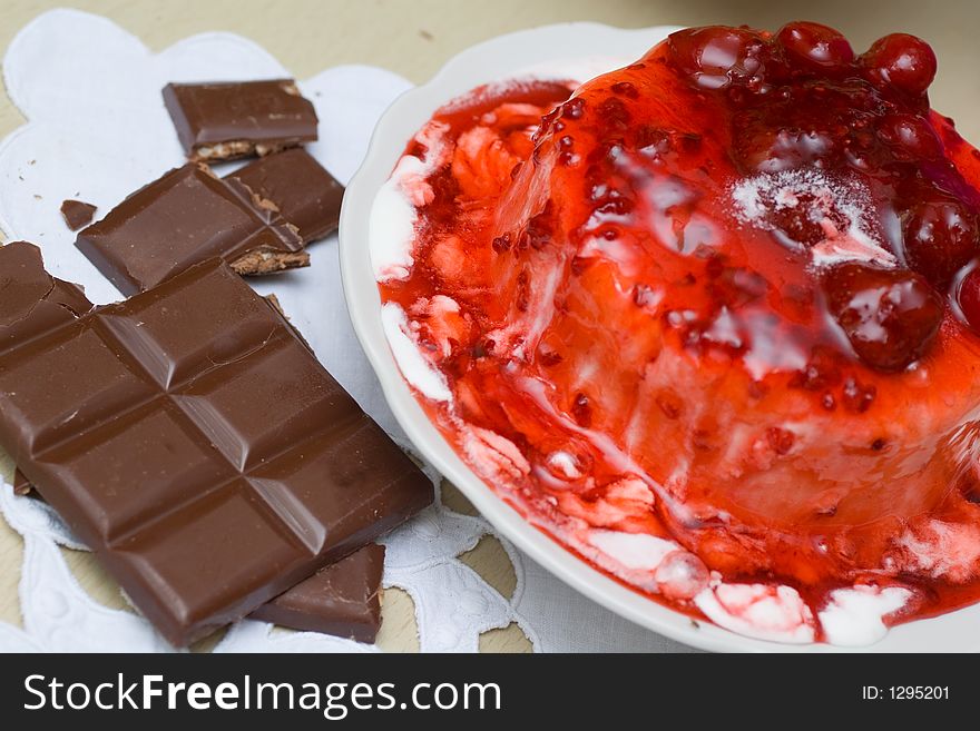 Ice-cream pudding poured with sweet cherry jam, with chocolate bar. Ice-cream pudding poured with sweet cherry jam, with chocolate bar.