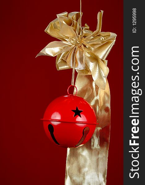 Red Christmas bell with golden ribbon over red background. Red Christmas bell with golden ribbon over red background.