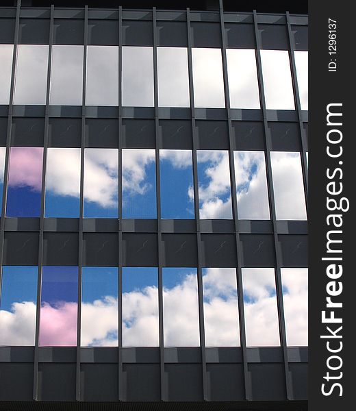 Blue sky and white clouds in the windows of a building. Blue sky and white clouds in the windows of a building