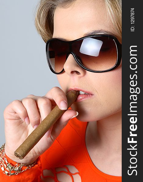 Blond Woman Smoking A Cigar With Sunglasses