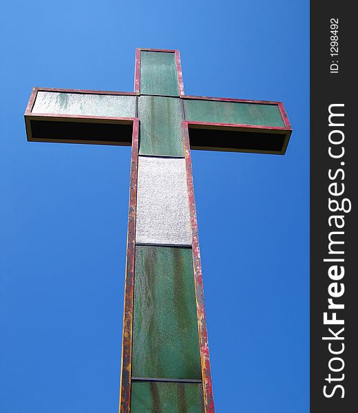 An old cross set against the clear blue sky. An old cross set against the clear blue sky