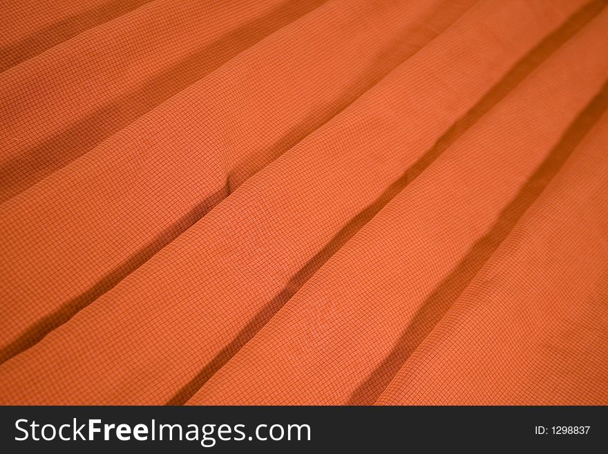 Orange material replicate with fan shape stripes in perspective. Orange material replicate with fan shape stripes in perspective