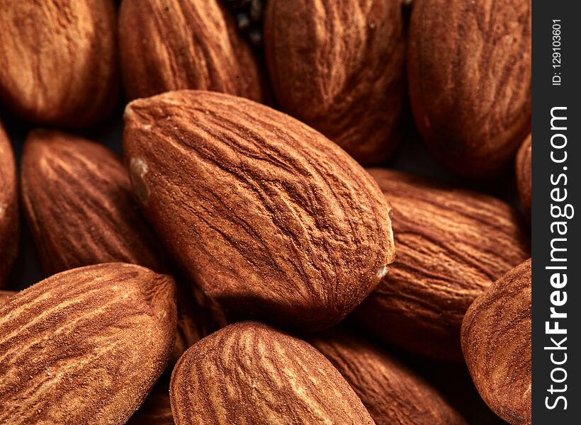 Organic texture of almonds. View from above. Almonds macro background. Almond nuts with soft focus.