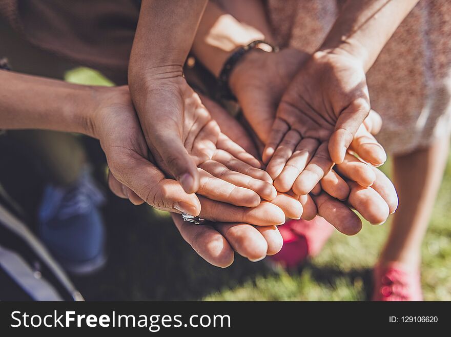 Family support. Strong men standing close to his relatives and showing his palms. Family support. Strong men standing close to his relatives and showing his palms