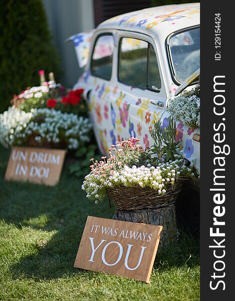 Car Painted With Flowers, Surrounded By Bouquets Of Flowers, Wedding Decor