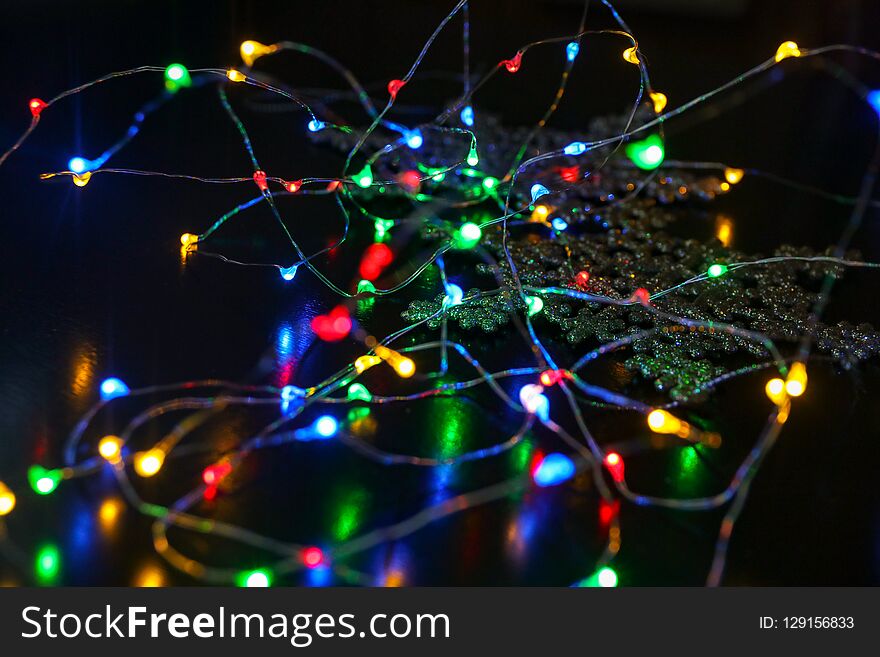 New Year Garland With Little Lamps On Black Background With Snowflake