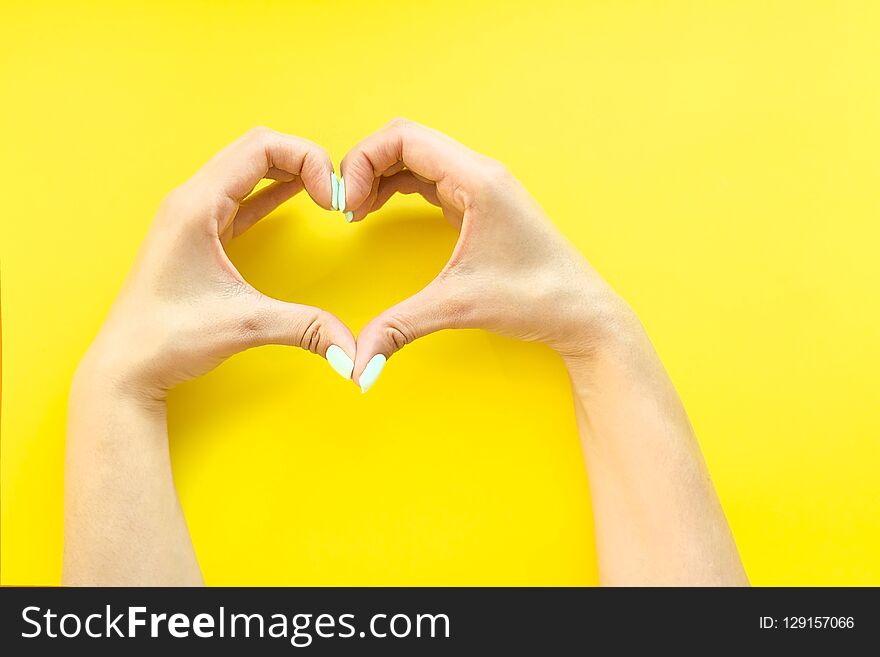 Heart From Hands On A Yellow Background