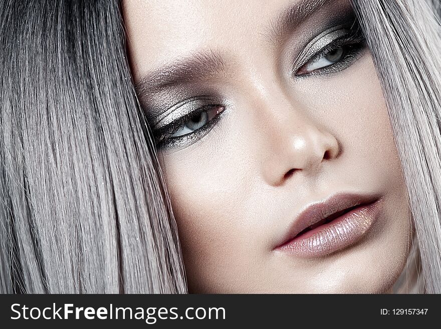 Young beautiful girl with silver make-up and ash hair