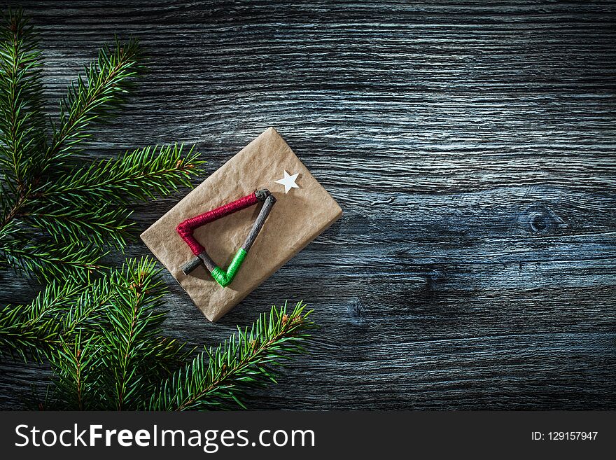 Pine tree branches gift box on wooden board