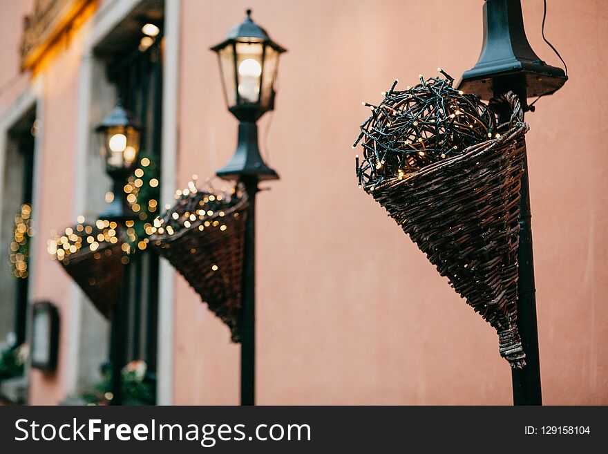 Traditional Christmas Decorations In The Street In Warsaw. Decorated Lampposts With Garlands