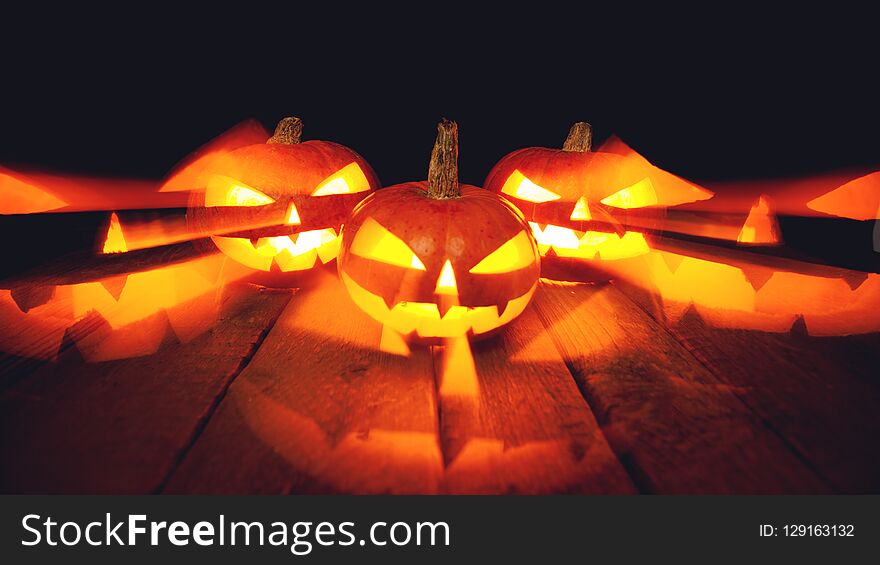 Three Halloween Pumpkins on dark background