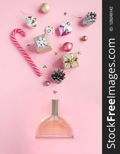 Perfume bottle different christmas decoration on pink background. Open perfume concept. Flat lay. Perfume bottle different christmas decoration on pink background. Open perfume concept. Flat lay.