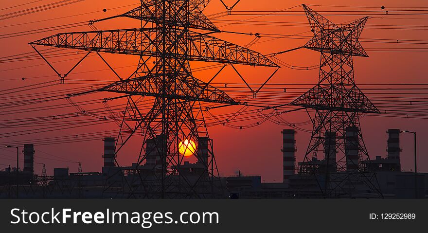 High voltage electricity pole at sunset. energy concept, industrial photo