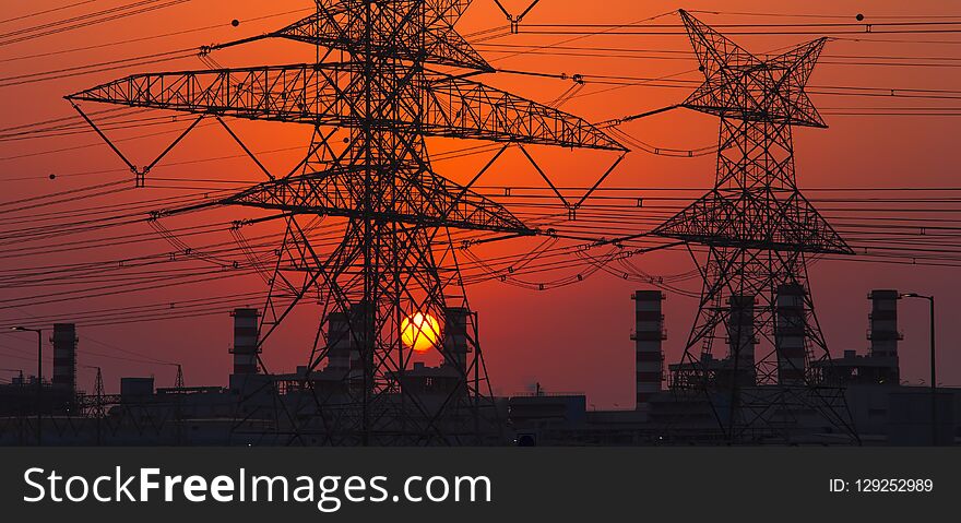 High Voltage Electricity Pole At Sunset. Energy Concept