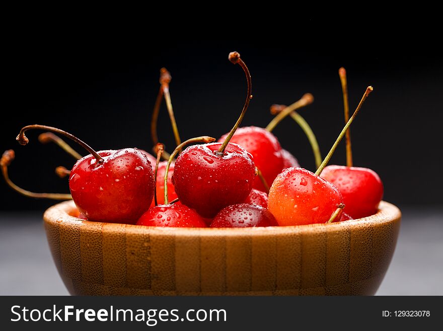Photo of sweet cherry in wooden cup