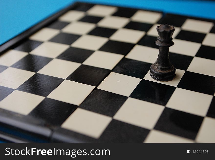 An old dusty chess board with a tower on it