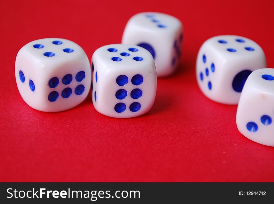 Five dices in a row on a black background