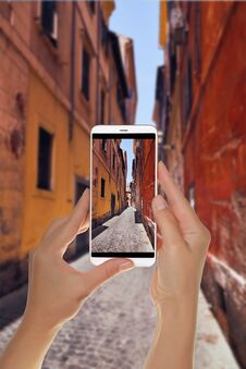 Tourist Makes A Photo Of Narrow Italian Street In Rome Stock Photography