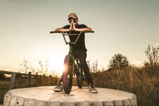 BMX Rider At Sunset. Guy Riding A Bmx Bike Stock Images