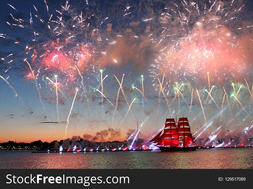 A ship with red sails, and fireworks, in the Neva water area on the day of the celebration of the graduates Scarlet-Sails