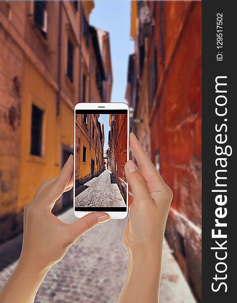 Tourist Makes A Photo Of Narrow Italian Street In Rome