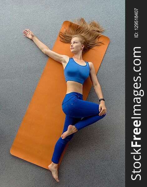 Sportswoman on yoga mat