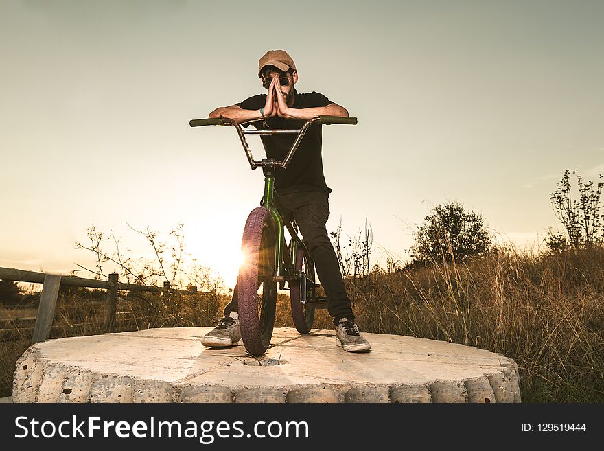 BMX Rider At Sunset. Guy Riding A Bmx Bike