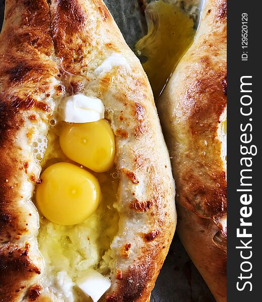 Ajarian khachapuri Georgian cheese pie with egg close-up.