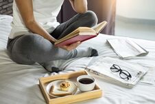 Woman Reading Book Or Newspaper And Drinking Coffee Breakfast On Stock Images