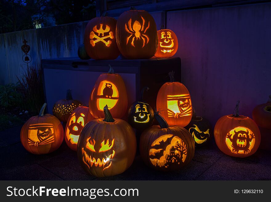 Spooky carved Halloween pumpkins illuminated with candles