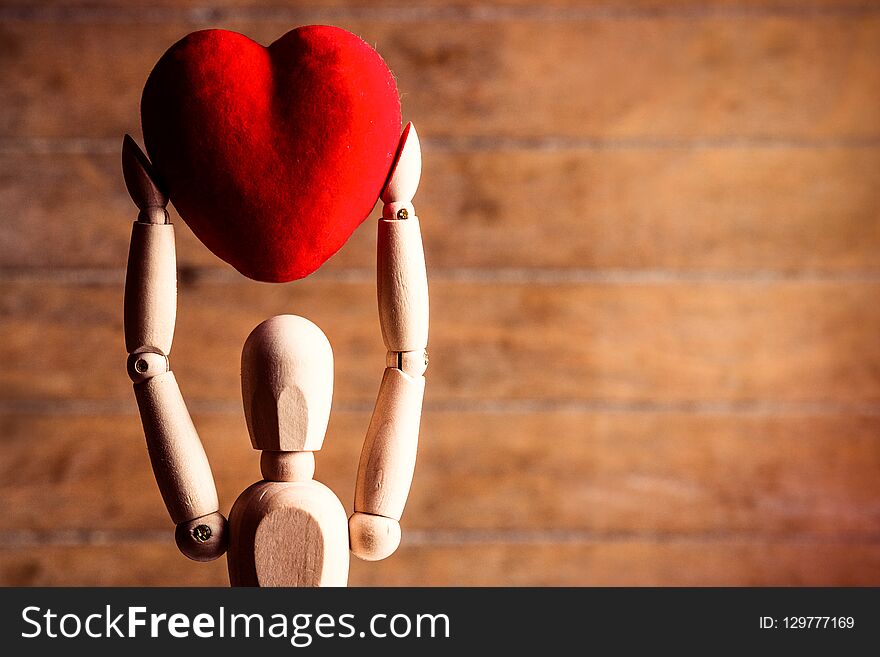 Photo of the beautiful gestalta with heart-shaped toy on the brown wooden background