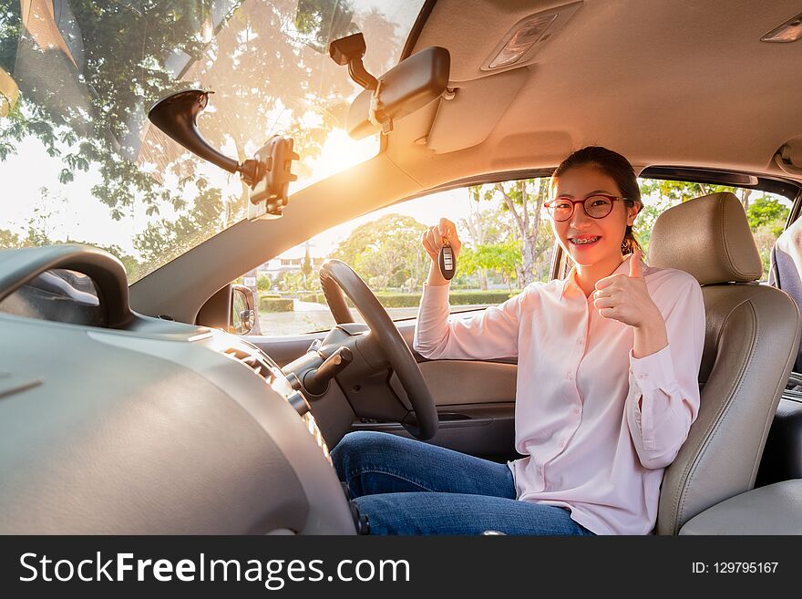 Young Woman Holding A Key Of Her New Car, Sale Car Concept