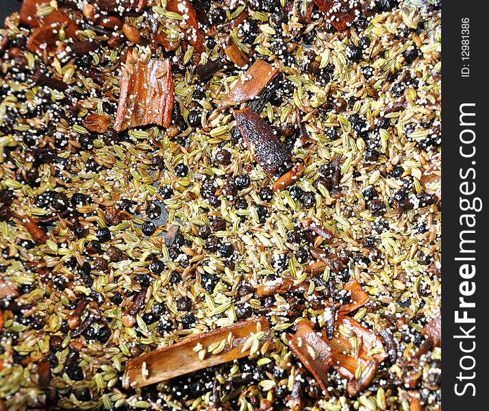 Detail of Coriander seeds and papper in fry pan with hot oil