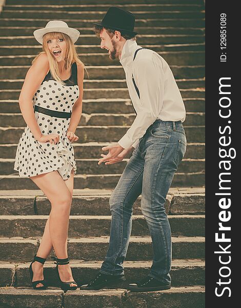 Summer holidays love relationship and dating concept - romantic playful couple retro style flirting on city stairs. Summer holidays love relationship and dating concept - romantic playful couple retro style flirting on city stairs