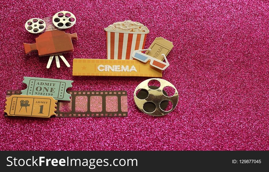 Cinema Sign With Popcorn Bucket 3d Glasses Movie Tickets On Film Strip With A Reel On A Dark Pink Background