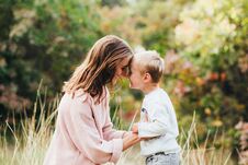 Free Mom And Son Hug And Laugh In The Autumn Park. Space For Text. Royalty Free Stock Photography - 129900977